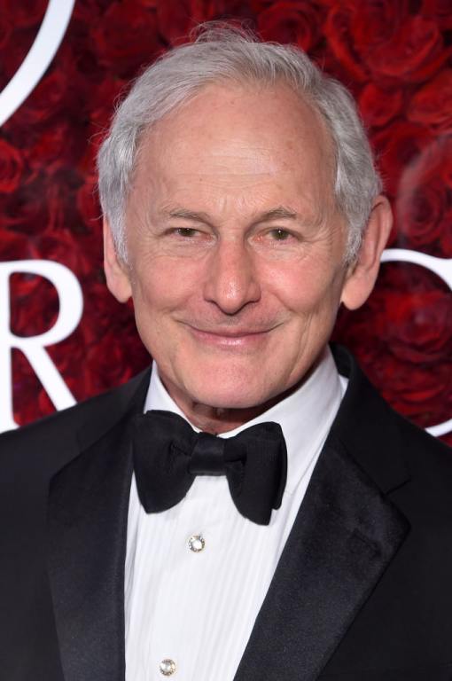 Victor Garber smiling wearing a tuxedo and bowtie.