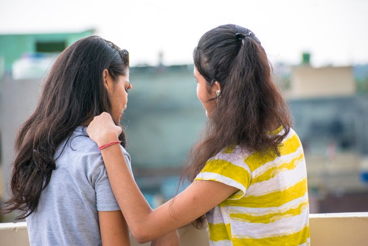 Girl trying to comfort to her sad friend