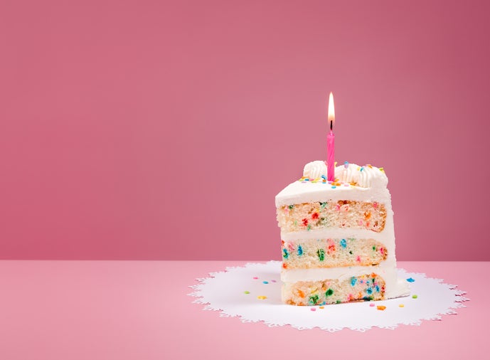 Slice of Birthday Cake with Candle on Pink