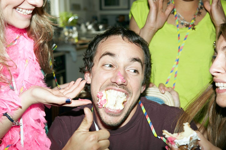 Man with his mouth full of cake