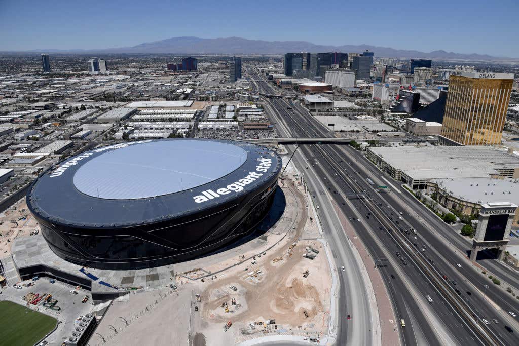 LAS VEGAS, NEVADA - MAY 21: An aerial view shows hotel-casinos on the Las Vegas Strip east of the construction continuing at Allegiant Stadium, the USD 2 billion, glass-domed home of the Las Vegas Raiders on May 21, 2020 in Las Vegas, Nevada. Natural grass turf now covers the large field tray that sits on rollers that will move the field in and out of the stadium. The Raiders are scheduled to play their first preseason game at the 65,000-seat facility on August 27 against the Arizona Cardinals. (Photo by Ethan Miller/Getty Images)