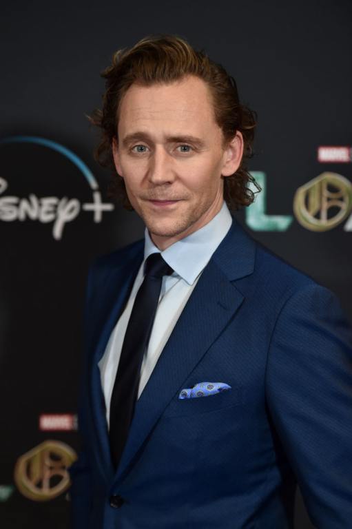 Tom Hiddleston wearing a suit on a Loki red carpet event.