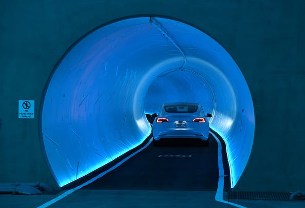 AS VEGAS, NEVADA - APRIL 09: A Tesla car drives through a tunnel in the Central Station during a media preview of the Las Vegas Convention Center Loop on April 9, 2021 in Las Vegas, Nevada. The Las Vegas Convention Center Loop is an underground transportation system that is the first commercial project by Elon Musk’s The Boring Company. The USD 52.5 million loop, which includes two one-way vehicle tunnels 40 feet beneath the ground and three passenger stations, will take convention attendees across the 200-acre convention campus for free in all-electric Tesla vehicles in under two minutes. To walk that distance can take upward of 25 minutes. The system is designed to carry 4,400 people per hour using a fleet of 62 vehicles at maximum capacity. It is scheduled to be fully operational in June when the facility plans to host its first large-scale convention since the COVID-19 shutdown. There are plans to expand the system throughout the resort corridor in the future. (Photo by Ethan Miller/Getty Images)