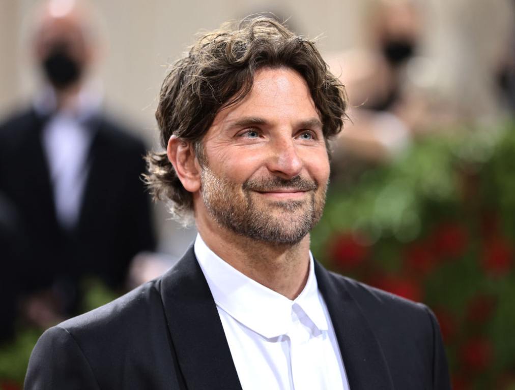 Bradley Cooper attends The 2022 Met Gala Celebrating "In America: An Anthology of Fashion" smiling looking right wearing a tuxedo.