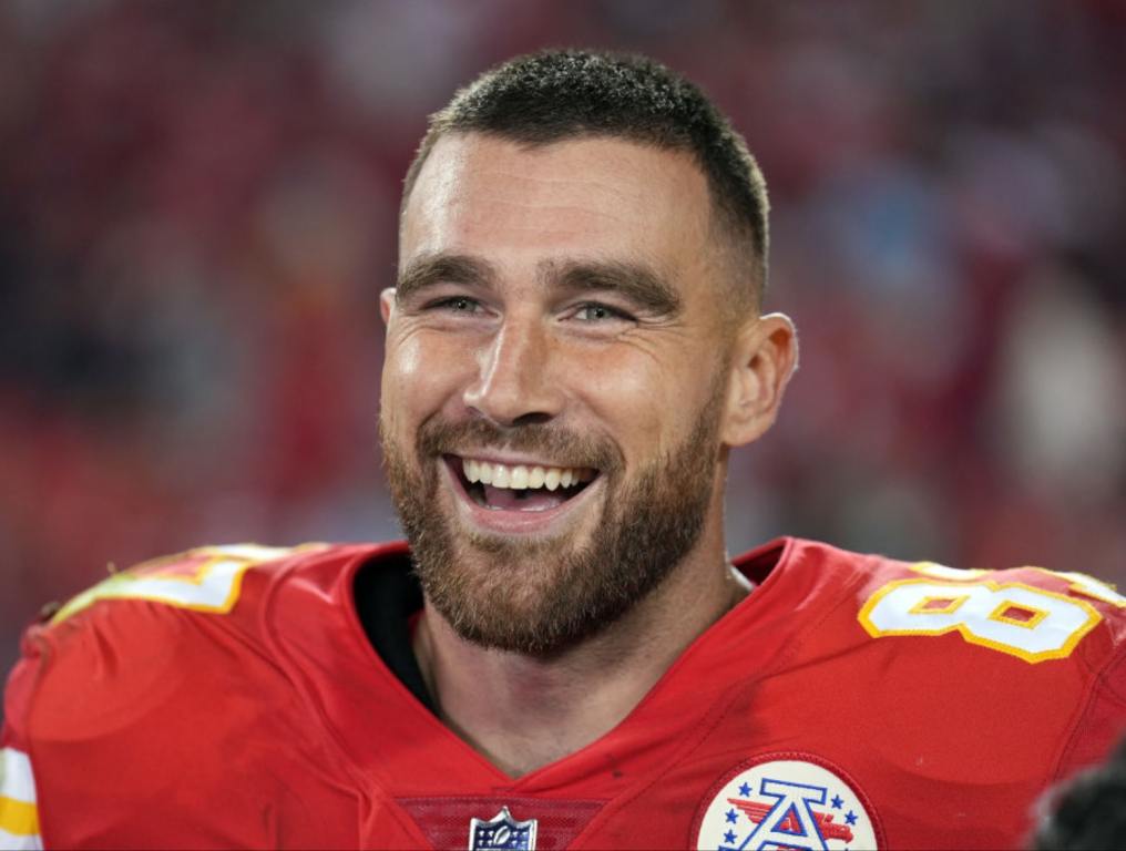 Travis Kelce #87 of the Kansas City Chiefs smiles while being interviewed after the Chiefs defeated the Las Vegas Raiders 30-29 to win the game at Arrowhead Stadium on October 10, 2022 in Kansas City, Missouri.