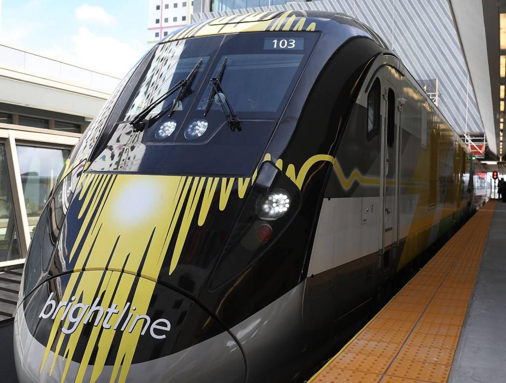 front of a brightline brand train at the station