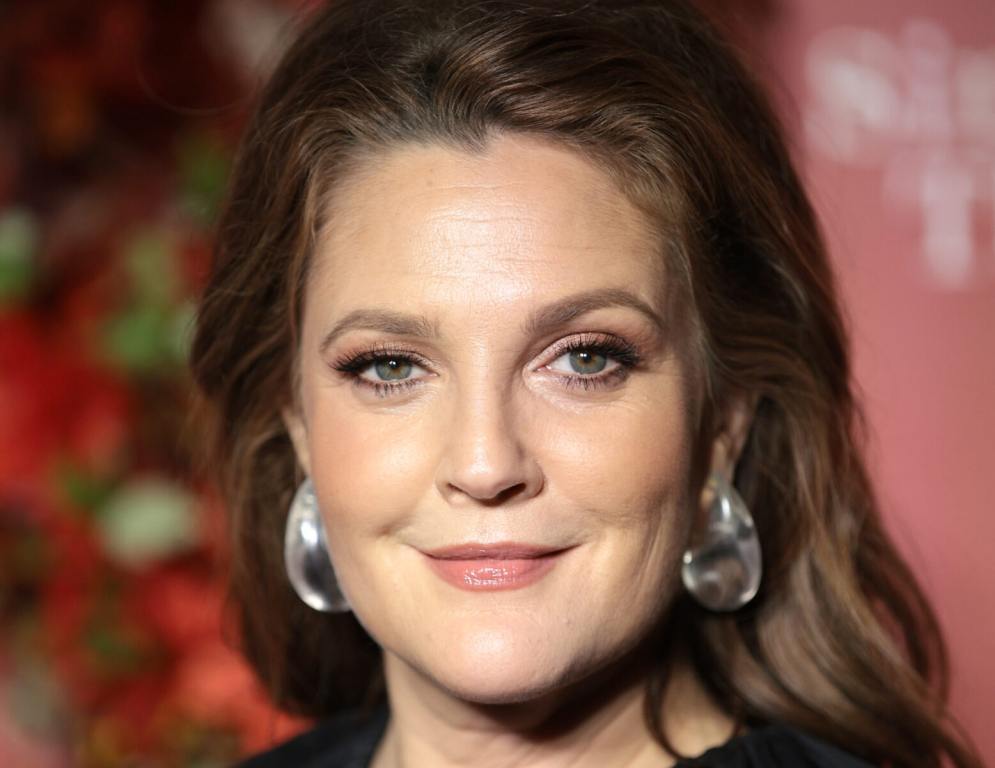 Drew Barrymore attends the Clooney Foundation For Justice Inaugural Albie Awards smiling in a close-up shot wearing silver earrings.