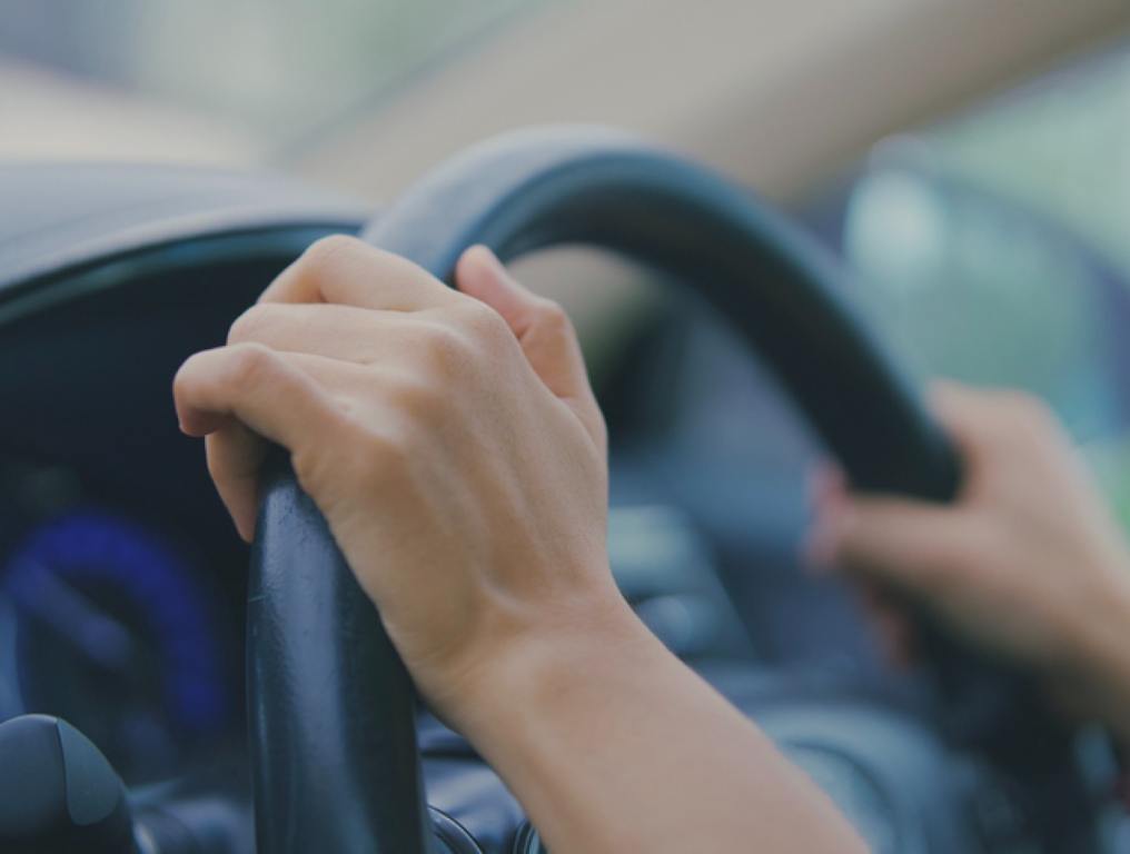 Woman's hand, holding, steering wheel, car, driving.