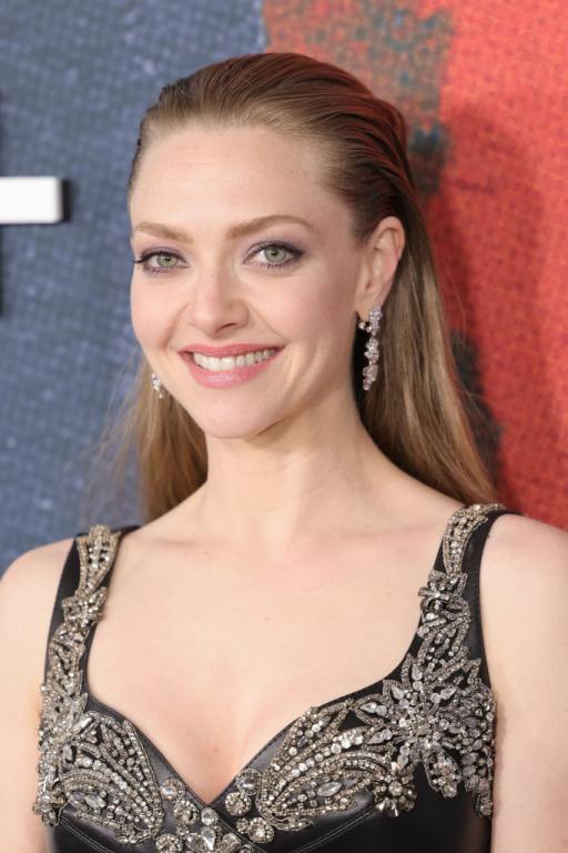 Amanda Seyfried attends Apple TV+'s "The Crowded Room" New York Premiere smiling wearing a black and gold gown.