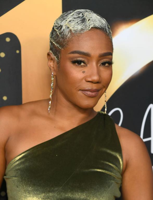 Tiffany Haddish attends the Hollywood Confidential 10 yr Anniversary W. Marla Gibbs, Tabitha Brown Tiffany Haddish wearing a green one-shoulder velvet dress.