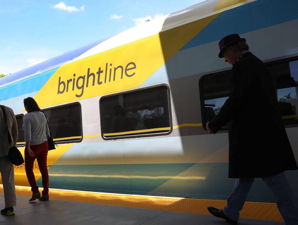 Brightline train at station with people walking by