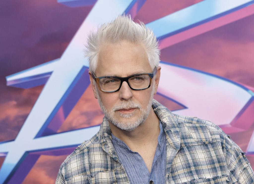 James Gunn attends Warner Bros. "Blue Beetle" Los Angeles Special Screening wearing a plaid jacket over a blue shirt.