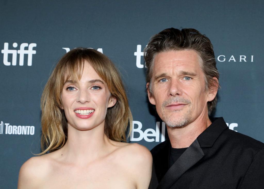 Maya Hawke and Ethan Hawke attend the "Wildcat" premiere during the 2023 Toronto International Film Festival smiling facing left.