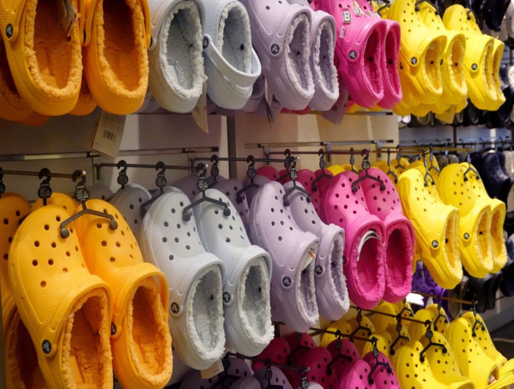 Wall of varied colored Crocs shoes