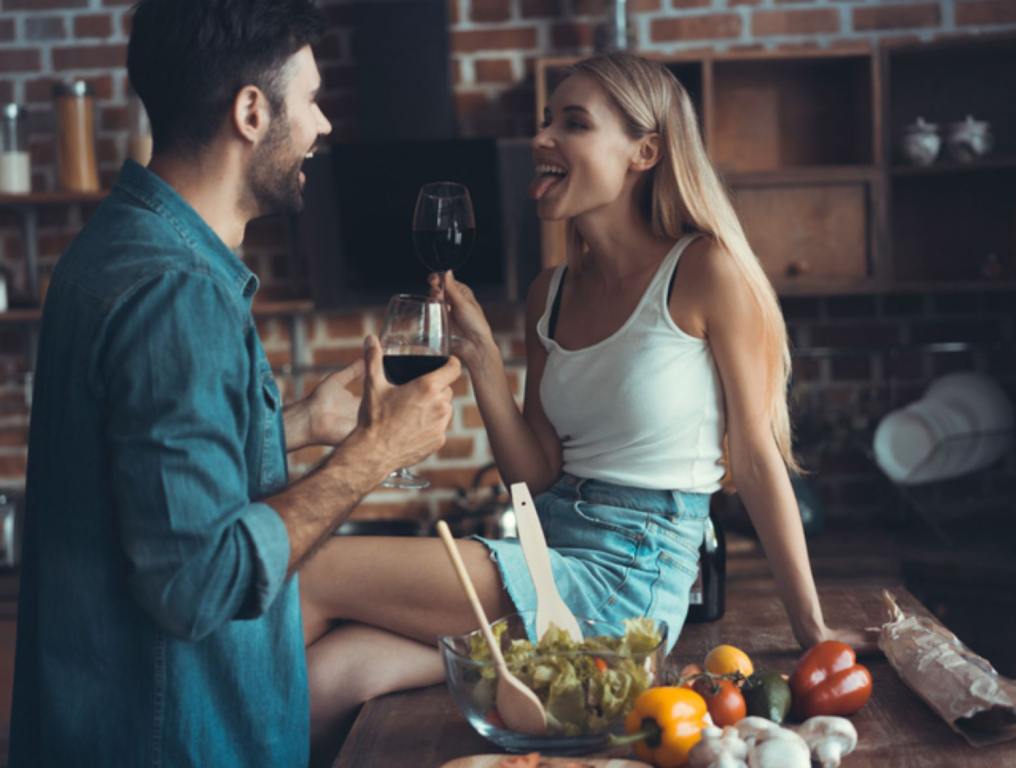 Couple on a date with girl playfully sticking her tongue out at her date.