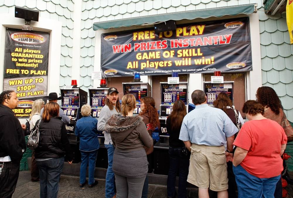 people gathered around slot machines outdoors