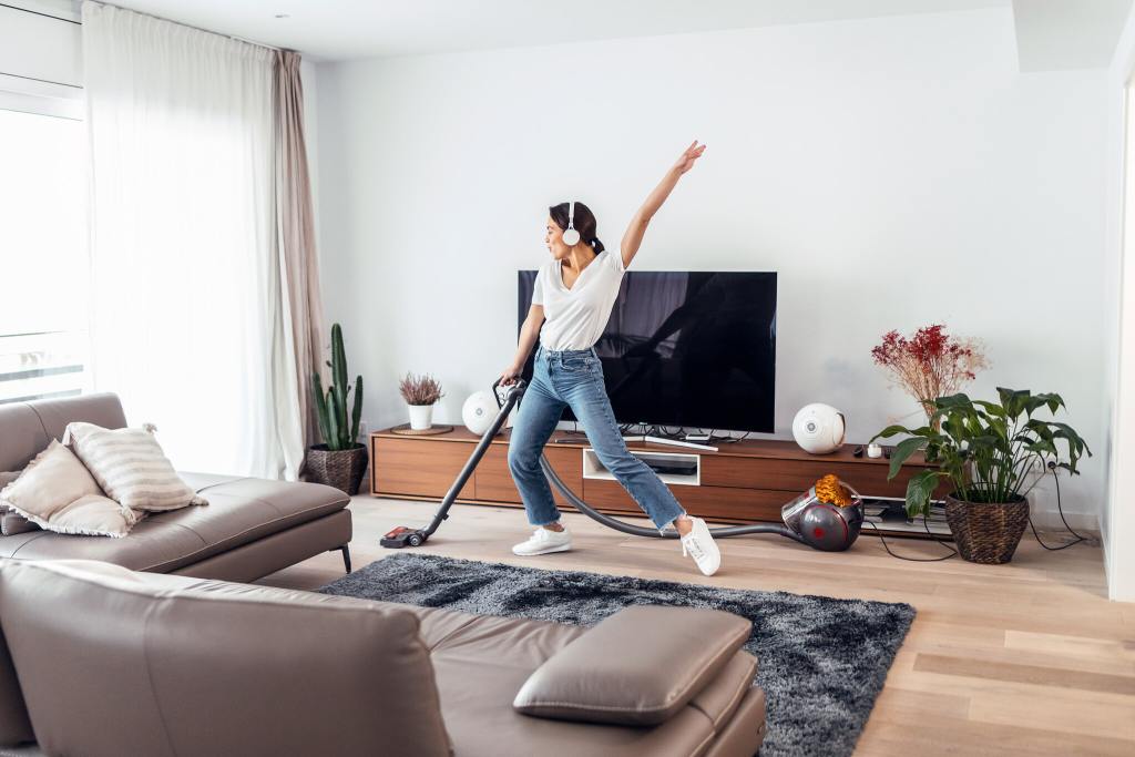 woman cleaning living room