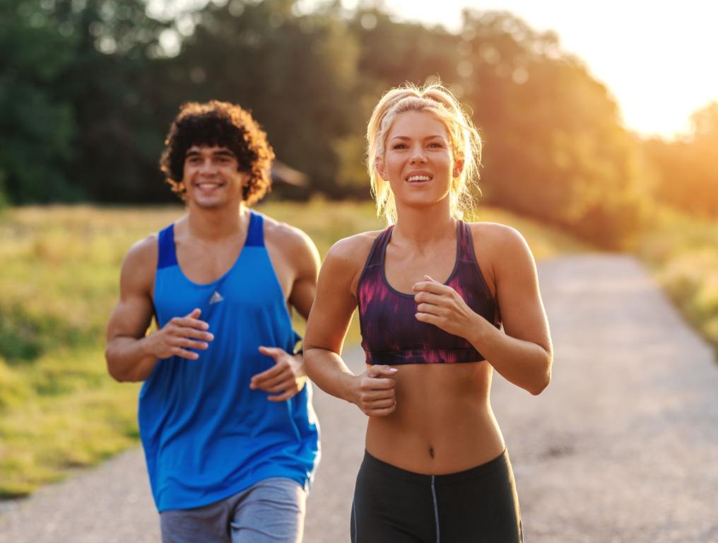 Blonde woman and brunette man running.