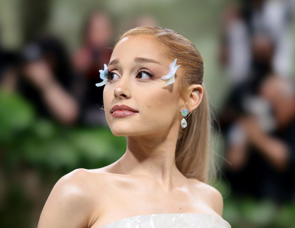 Ariana Grande attends The 2024 Met Gala Celebrating "Sleeping Beauties: Reawakening Fashion" facing left wearing a pearl corset and butterfly adornments on the corners of her eyes, Ariana Grande Slammed For Saying Jeffrey Dahmer Is Her Dream 'Dinner Guest'.