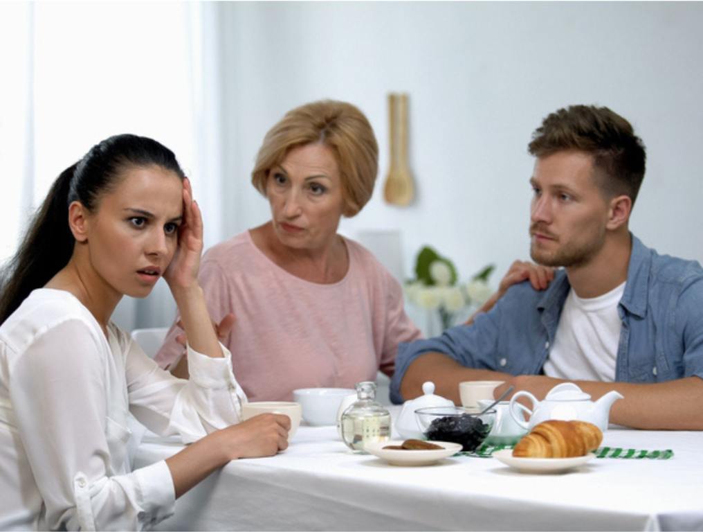 Serious mother teaching daughter-in-law to behave, toxic in-laws concept