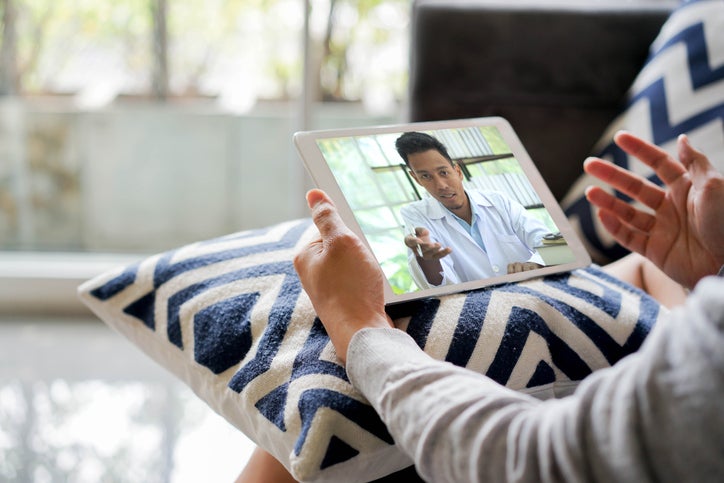 close up rear view of young man video conference to consulting about male hormone and physical with specialist and listen explaining at home for telemedicine health technology life concept