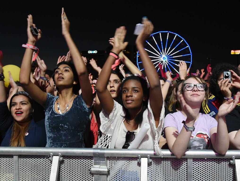 concertgoers behind a barricade. life is beautiful block party lineup