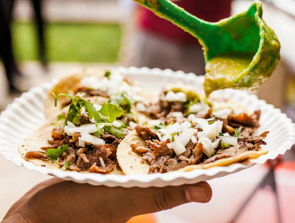 plate of street tacos with salsa being poured on. Henderson street vendor rules