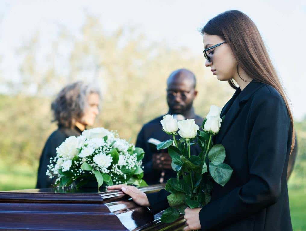 woman mourning aside a casket stolen in las vegas