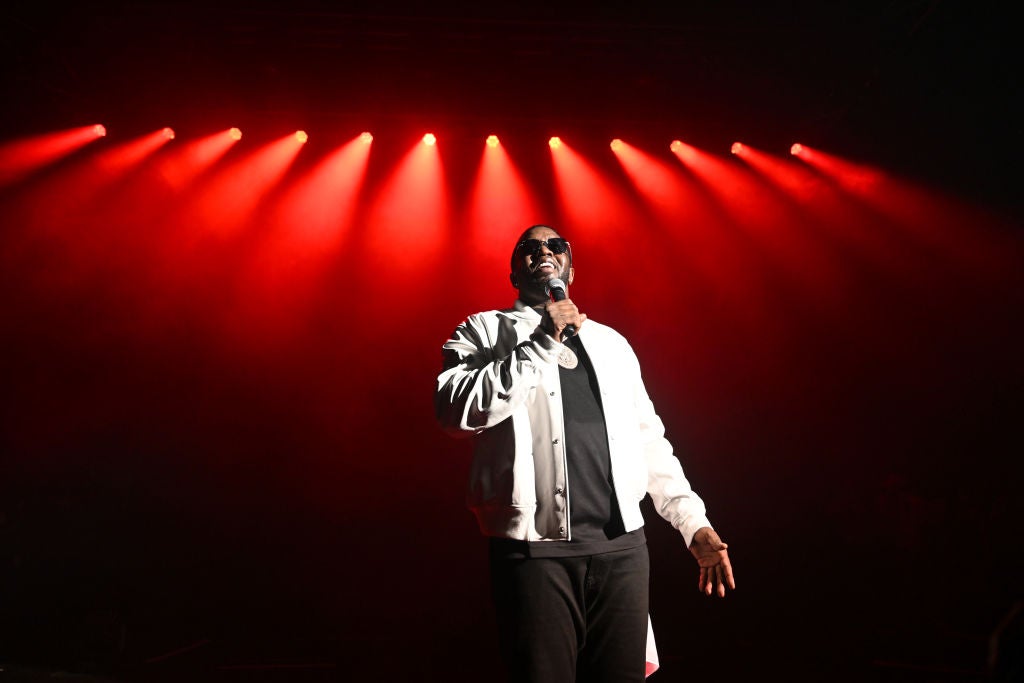 Diddy on stage under red lights