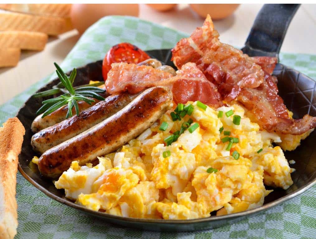 A skillet filled with scrambled eggs, sausage, bacon and potatoes. Concept: Best Breakfast Joints in Las Vegas