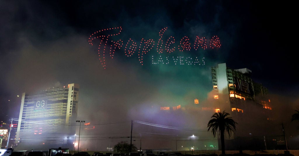 The 23-story Paradise (L) and Club hotel towers of the Tropicana Las Vegas are imploded as 555 drones by Fireworks by Grucci spell out "Tropicana Las Vegas" between them on October 09, 2024 in Las Vegas, Nevada. The hotel-casino opened in 1957 and closed permanently in April 2024 to make way for a planned USD 1.5 billion, 33,000-seat domed stadium for Major League Baseball's Oakland Athletics and a related resort development by Bally's Corp. and Gaming and Leisure Properties Inc. MLB owners approved the team's relocation to Nevada in November 2023, and the A's hope to move into the ballpark, which will occupy nine acres of the 35-acre site, in 2028.