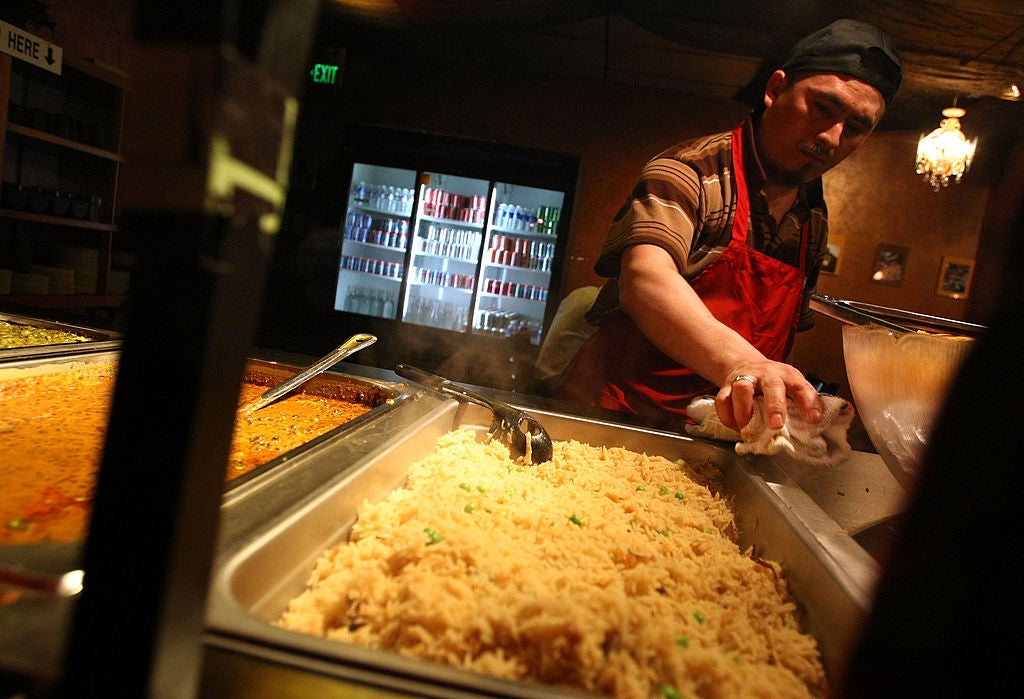 Worker cleaning a buffet. The Largest Buffet In America Is Somehow Not In Las Vegas