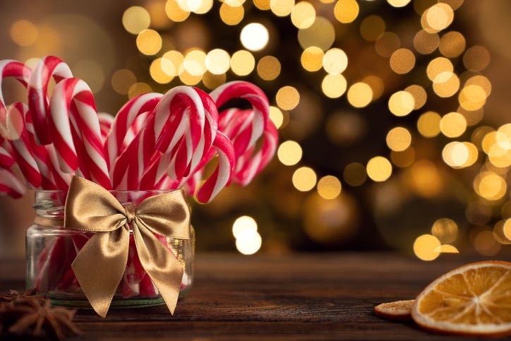 Candy canes in the glass jar on the christmas table